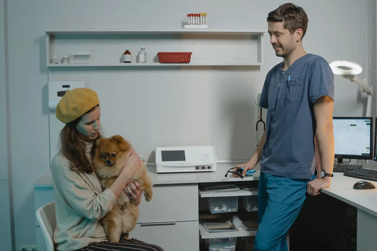 Recepción de una clínica veterinaria con una clienta satisfecha que recomienda el servicio